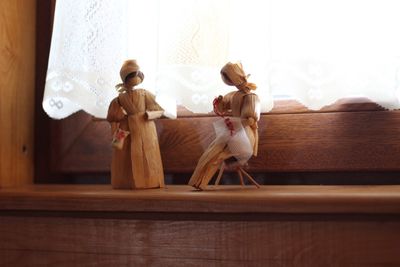 Friends sitting on table at home