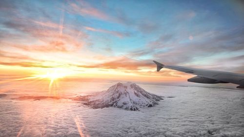 Aerial view of mountain peak surrounded by clouds