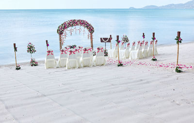 Chairs and gate arranged at beach