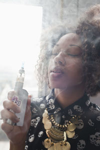 Young woman using an electronic cigarette