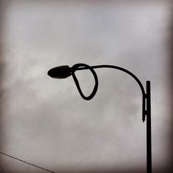 Low angle view of lamp post against the sky