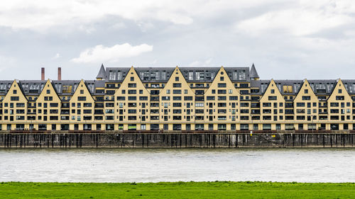 View of river by city against sky