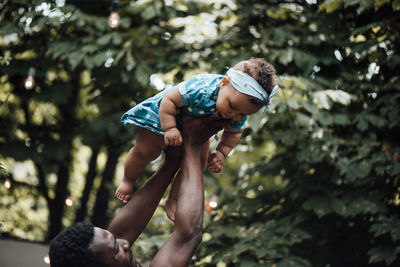 Father playing with daughter outdoors