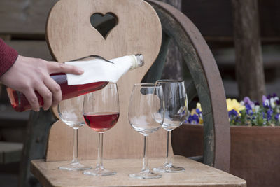 Midsection of woman holding wineglass