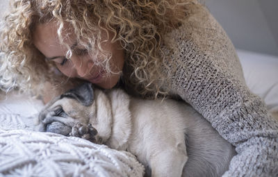 Woman embracing dog at home