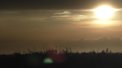 Scenic view of silhouette landscape against sky at sunset