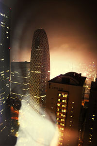 Illuminated buildings against sky at night