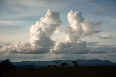 Scenic view of mountains against cloudy sky