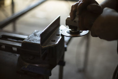 Cropped hand of man repairing car