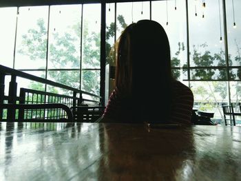 Woman sitting on railing