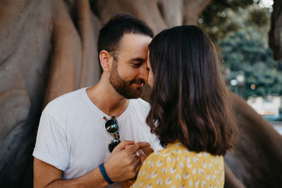 Side view of senior couple kissing while standing outdoors