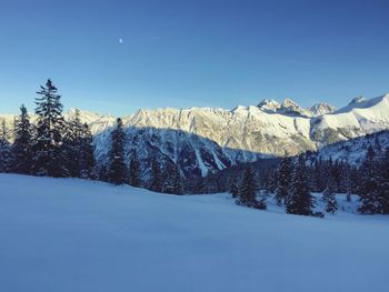 Scenic view of snow covered landscape against clear sky