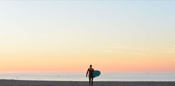 Rear view of man standing on beach