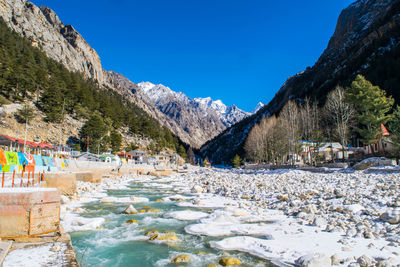 Scenic view of mountains against clear blue sky