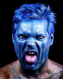 Portrait of man with blue facepaint