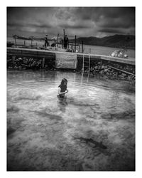 People on water against sky