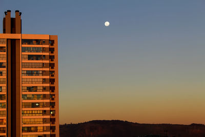 Buildings against sky at sunset