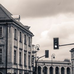 Low angle view of building against cloudy sky