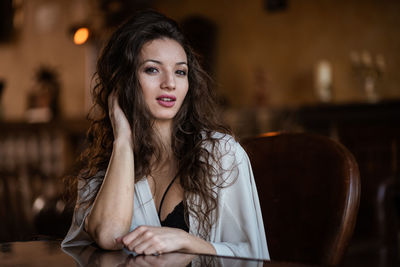 Portrait of young woman sitting outdoors