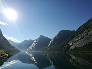 Scenic view of river amidst mountains against sky