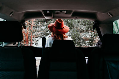 Rear view of man sitting in bus