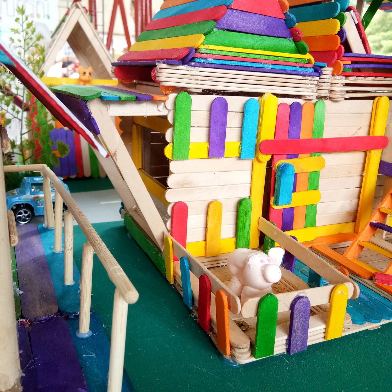 HIGH ANGLE VIEW OF MULTI COLORED TOY ON TABLE