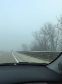 Snow covered road seen through car windshield