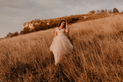 Rear view of woman standing on field