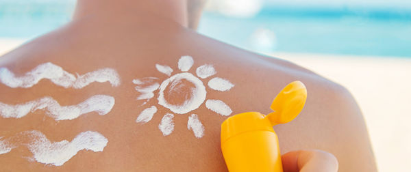 Close-up of woman hand on beach