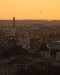 Aerial view of buildings in city during sunset