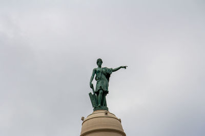 Low angle view of statue against sky