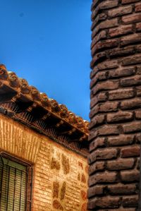 Low angle view of built structure against clear blue sky