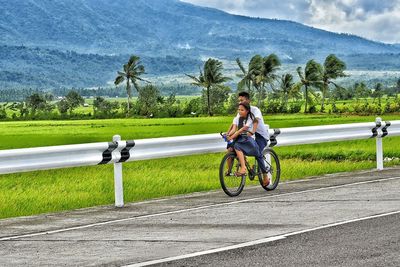 Woman riding bicycle on mountain