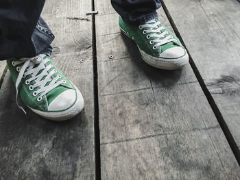 Low section of man standing on footpath