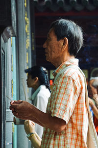 Portrait of young man standing at home