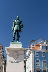 Low angle view of statue against clear blue sky