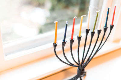 Menorah with unlit candles for hanukkah celebrations in a window.