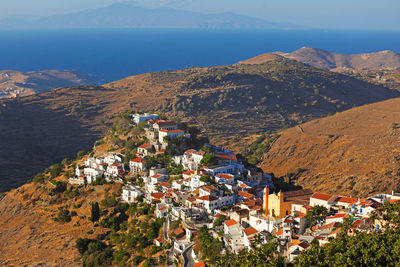 High angle view of townscape by sea against sky