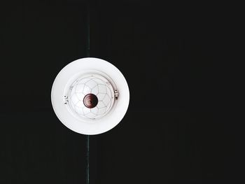 Low angle view of illuminated pendant in darkroom