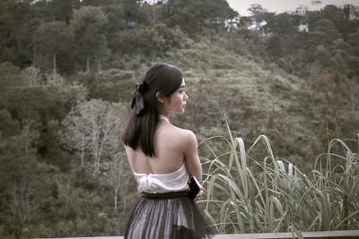 Side view of woman standing on field