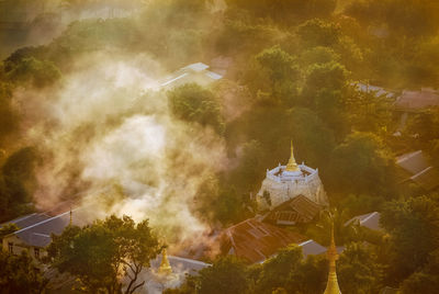 Aerial view of building and trees against sky