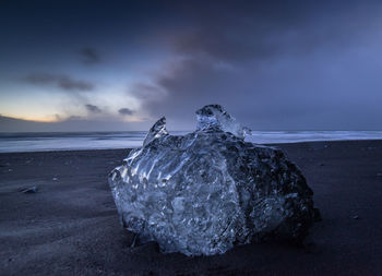 Sea shore against sky during sunset