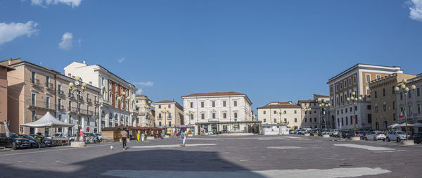  extra wide angle view of the beautiful piazza duomo in l'aquila with historic buildings and churche
