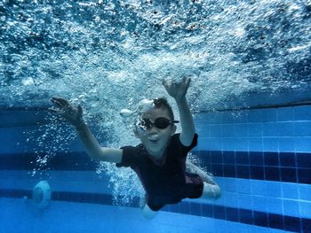 Boy swimming in pool