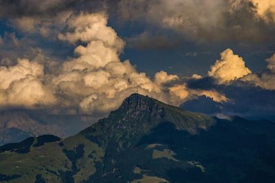 Low angle view of mountains against cloudy sky