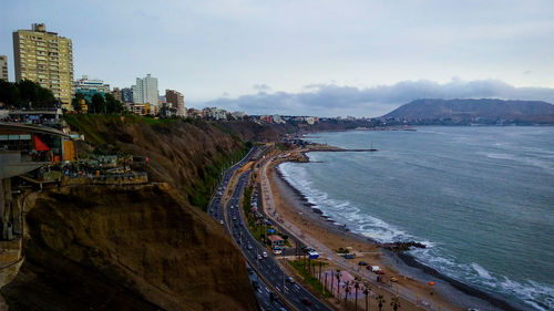 High angle view of sea and buildings against sky