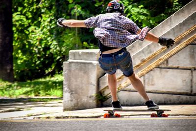 Full length of man skateboarding in city