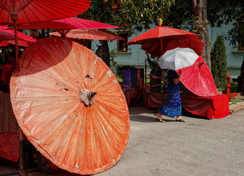 Rear view of woman walking with umbrella