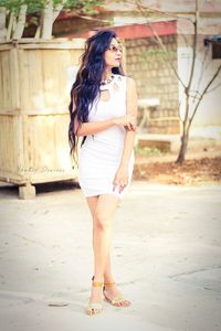 Full length of woman standing by railing