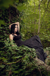 Beautiful woman looking away in forest